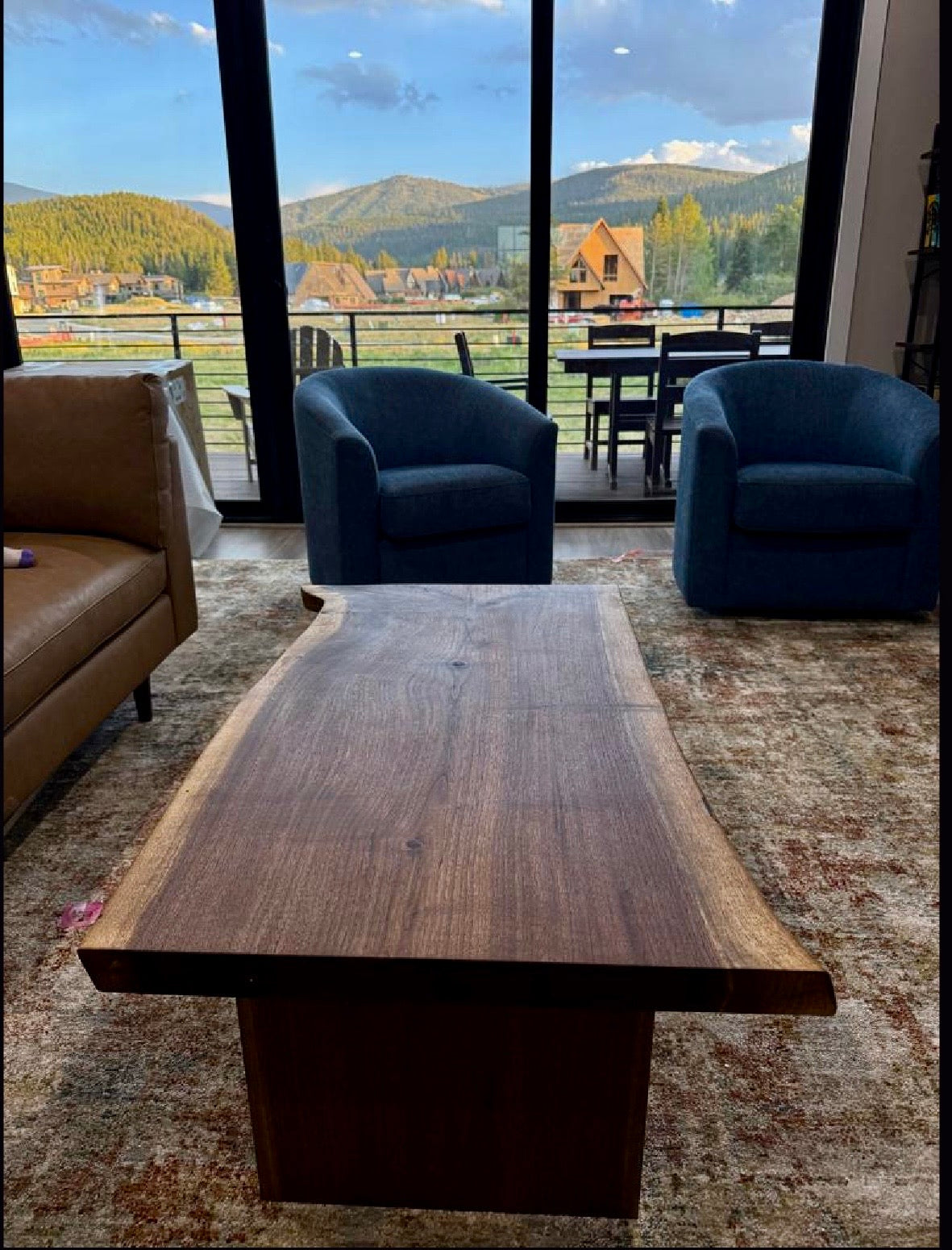 Custom walnut live-edge desk in a modern mountain-view interior
