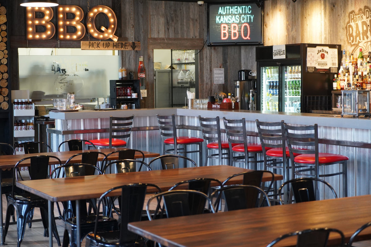 Custom solid wood restaurant tables by Garage Mills in a commercial dining space
