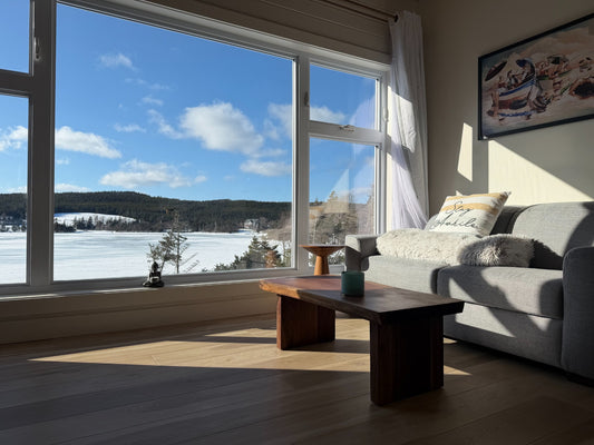 Garage Mills walnut live edge coffee table in a bright lake-view customer living room